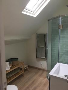 a bathroom with a glass shower and a sink at Belle Vue Terrasse in Giverny