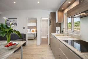 a kitchen with a sink and a counter top at Holiday Homes Kanajt in Punat