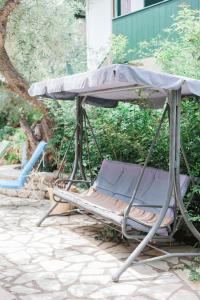 a couple of chairs sitting under an umbrella at Afroditi Pansion in Agios Nikitas