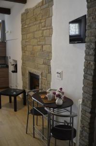 a living room with a table and chairs and a fireplace at B&B La Casa Sulla Roccia in Pietrapertosa