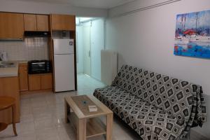 a living room with a couch and a table at Mary's room in Samos
