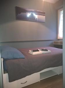 a bedroom with a bed with a picture on the wall at Charmant F2 Paris Expo Versailles in Vanves
