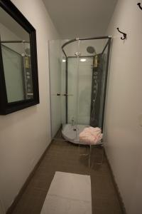 a bathroom with a shower and a bath tub at Jönköping Vandrarhem in Jönköping