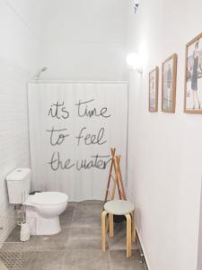a bathroom with a toilet and a sign on the wall at Pinheiro de Monsaraz-Casas da Colmeia T2 in Reguengos de Monsaraz
