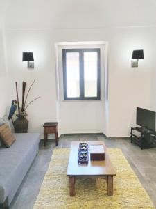 a living room with a couch and a coffee table at Pinheiro de Monsaraz-Casas da Colmeia T2 in Reguengos de Monsaraz