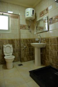 a bathroom with a toilet and a sink at City Square Bay View in Alexandria