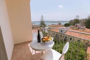 a bowl of fruit on a table on a balcony at Antares Rooms and Suites in Olbia