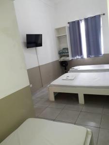 Postel nebo postele na pokoji v ubytování Hotel Aruba