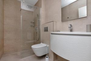 a bathroom with a toilet and a sink and a shower at Central Beach Apartments in Tučepi +38 photos