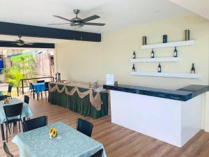 a restaurant with a bar with tables and chairs at Bentrina Diving Resort in Mabini