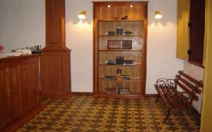 a room with chairs and a shelf with dishes at Pousada Solar Nossa Senhora Das Merces in Ouro Preto