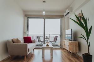 利馬索爾的住宿－Just a Seaview Apt. * Top Location * City Center *，带沙发和大窗户的客厅