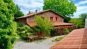 a red brick house with a red roof at Antaviana Cantabria in Cabezón de la Sal