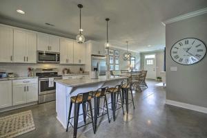 a large kitchen with a large clock on the wall at Downtown Retreat in Chattanooga