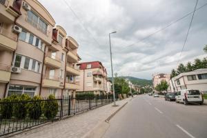 an empty street with buildings and a fence at Comfy Apartments-Ohrid in Ohrid