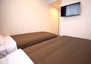 Postel nebo postele na pokoji v ubytování Hotel Trend Tobu Asakusa-Eki Kita