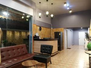 a living room with a couch and a bar at SleepCatsHostel in Bangkok