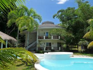 a house with a swimming pool in front of it at Bohol Dreamcatcher Resort in Panglao Island