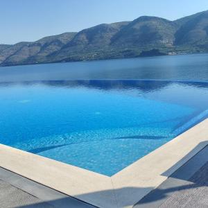 a view of a lake with mountains in the background at Blue Bay Apartments in Syvota