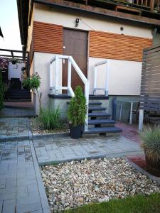 a building with stairs and a door and a patio at Apartament Natalia in Mrągowo
