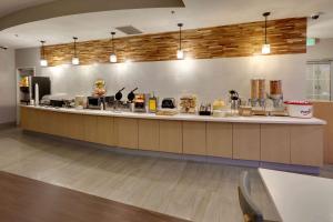 a large kitchen with a counter in a restaurant at La Quinta by Wyndham Dallas Love Field in Dallas