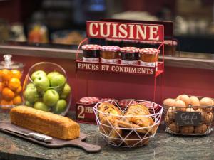 a counter with some baskets of bread and some fruit at ibis Styles Paris Nation Cours de Vincennes in Paris