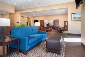 a living room with a blue couch and a table at Comfort Inn Tonopah in Tonopah