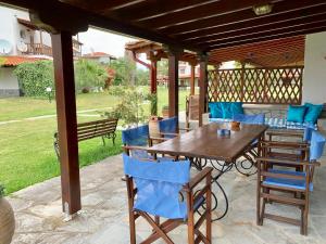 a wooden table and chairs on a patio at Villa Fourka 2 on the beach in Fourka