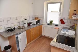 a kitchen with a sink and a counter top at Ferienwohnung Zentrum in Neuruppin