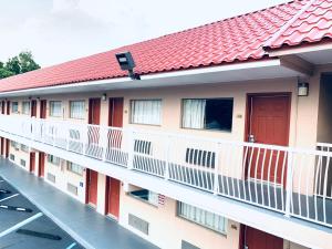 a balcony of a building with a red roof at Super 8 by Wyndham Ft Walton Beach in Fort Walton Beach