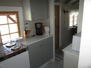 a kitchen with a sink and a counter top at Hesthaug Gard in Eidsdal