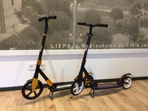 two scooters parked in front of a window at Simple & Elegant Apartment in Liepāja