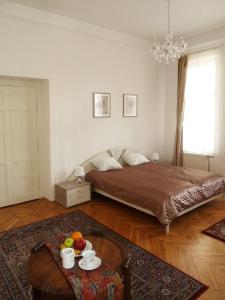 a bedroom with a bed and a table with fruit on it at Central Apartment in Veszprém