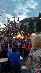 a crowd of people sitting in chairs at aestival at Central Apartment in Veszprém +41 photos