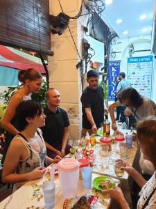 a group of people sitting around a table eating food at Cocoa Mews Cafe and Homestay in George Town