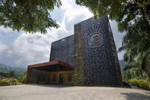 a building with a sign on the side of it at juSTa Rangers Munnar in Munnar