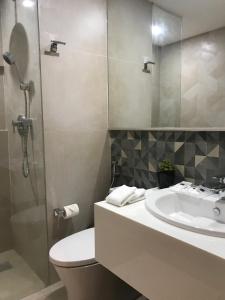 La salle de bains est pourvue de toilettes, d'un lavabo et d'une douche. dans l'établissement Avior Hotel, à General Santos