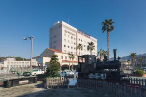 a train on display in front of a building at JR Hotel Clement Uwajima in Uwajima