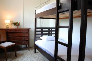 a bedroom with a bunk bed and a dresser at house in the village near the sea in Maleme