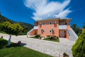 a large house with a stone driveway at Eleana Studios in Lefkada