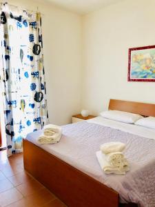 Postel nebo postele na pokoji v ubytování Casa Vacanza "La Piazzetta"