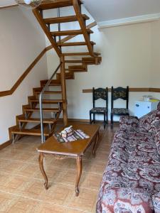 a living room with a couch and a wooden stairs at Anush restaurant/hotel in Vanadzor