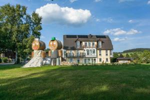 ein Haus mit einer Statue von zwei Menschen auf einem Feld in der Unterkunft Das gelbe Haus 3 in Winterberg