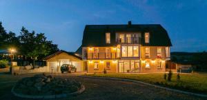 a large house with lights on the front of it at Das gelbe Haus 1 in Winterberg