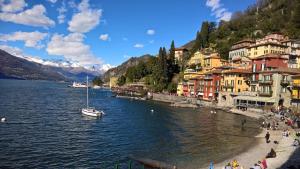 a group of people on the shore of a body of water at Camilla House in Varenna