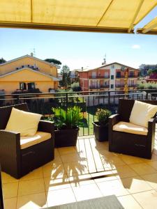 a balcony with two chairs and some plants at Aurelia House in Rome