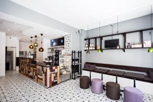 a room with a bar with purple stools at Eight Rooms in Stockholm