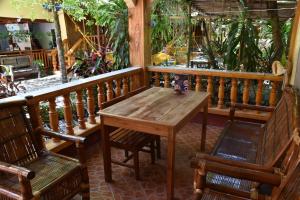 a wooden table and two chairs on a balcony at Roy's Rendezvous Boracay in Boracay