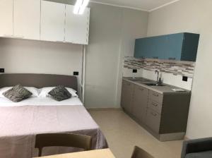 a bedroom with a large bed and a sink at Bed&Breakfast Luna in San Salvo