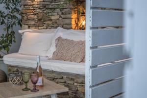 a bed in a room with a table at Small Paradise in Andros